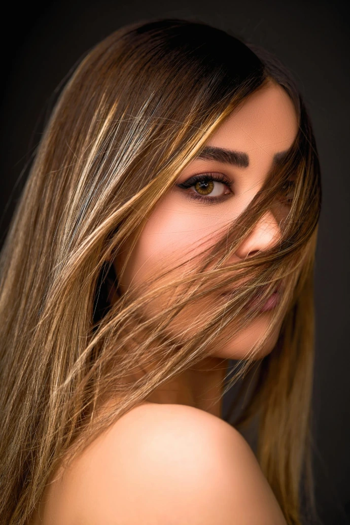 a woman with long hair is posing for a picture Organic Beauty Salon