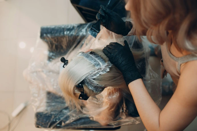 woman in black shirt lying on white textile Organic Beauty Salon